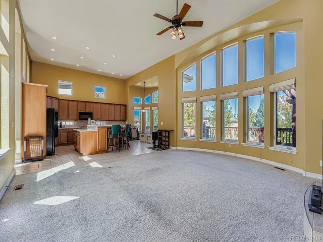 a view of an empty room with furniture and a large window