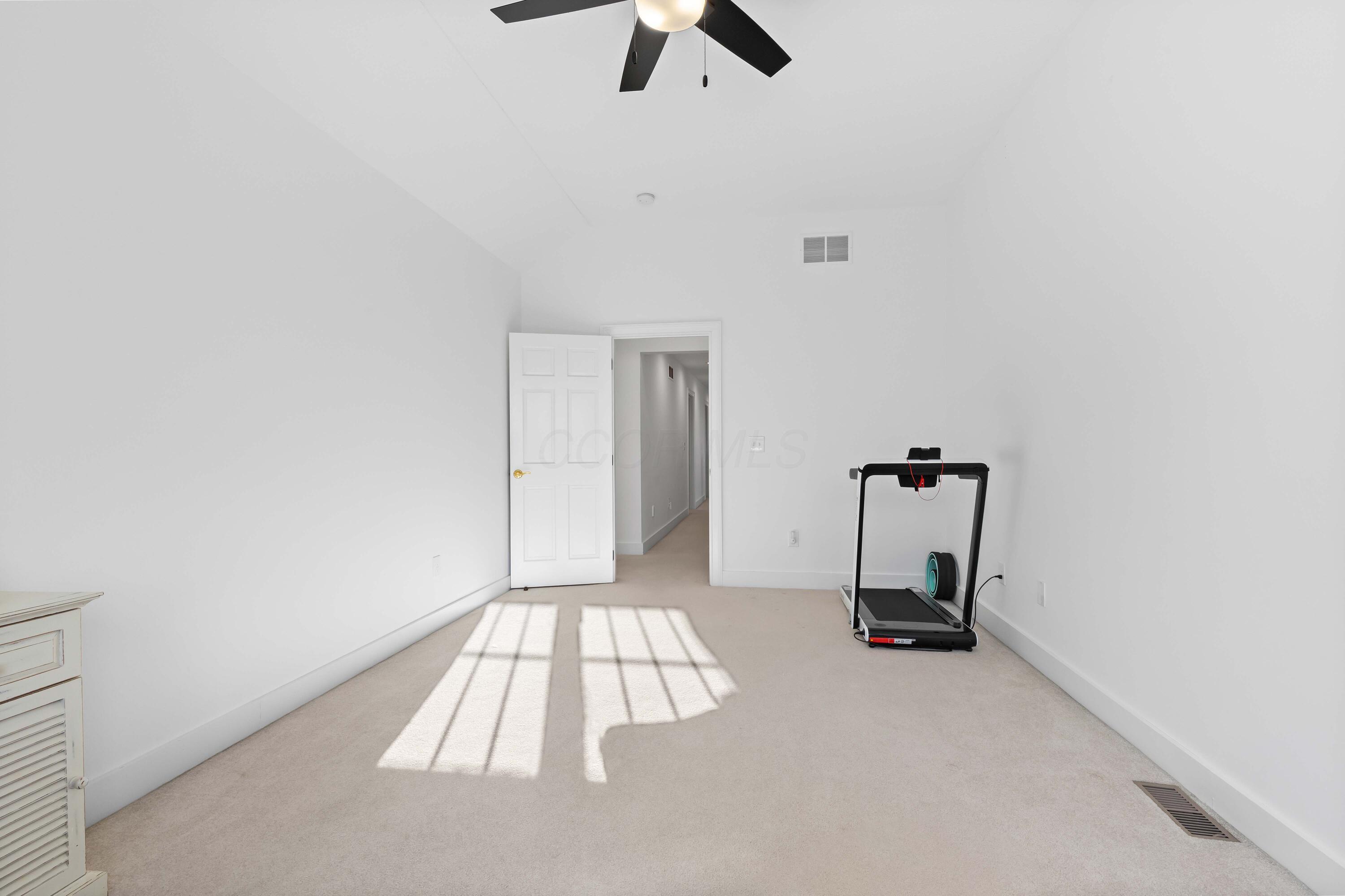 1364 Dale Ford Road Delaware, OH 43015 - Photo 71 of 112 • Light sand carpet • White painted walls • Lighted ceiling fan • Desk remains • Shades remain