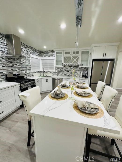 8952 McClure Avenue Westminster, CA 92683 - Photo 2 of 10 a dinning room with stainless steel appliances furniture a kitchen island a stove and a refrigerator