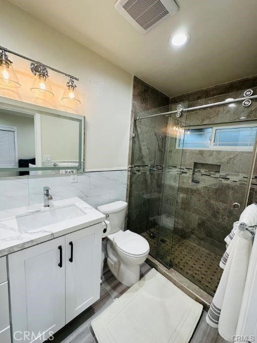 8952 McClure Avenue Westminster, CA 92683 - Photo 6 of 10 a bathroom with a sink toilet and shower