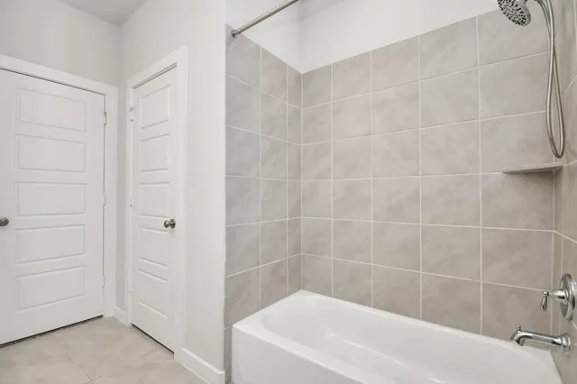 a white bath tub sitting next to a white sink and vanity