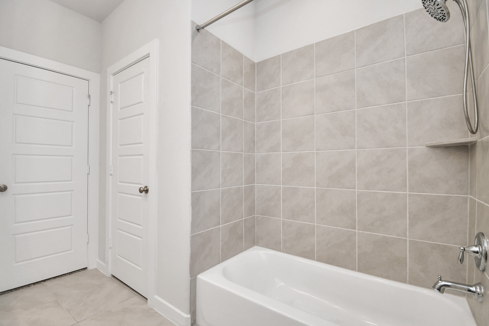 8213 Rising Stream Drive Houston, TX 77063 - Photo 15 of 21 a white bath tub sitting next to a white sink and vanity