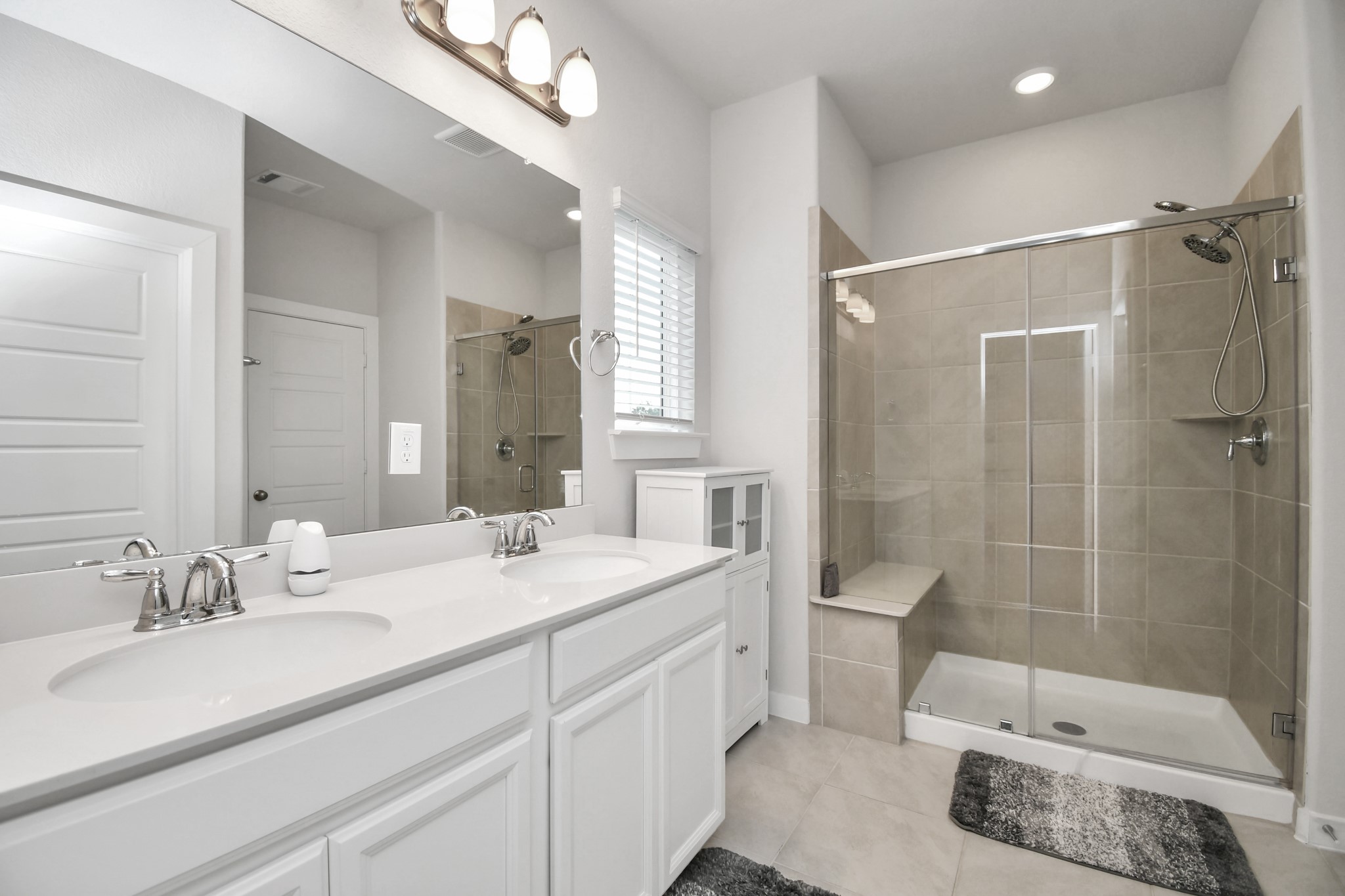 8213 Rising Stream Drive Houston, TX 77063 - Photo 16 of 21 a bathroom with a double vanity sink mirror double and shower