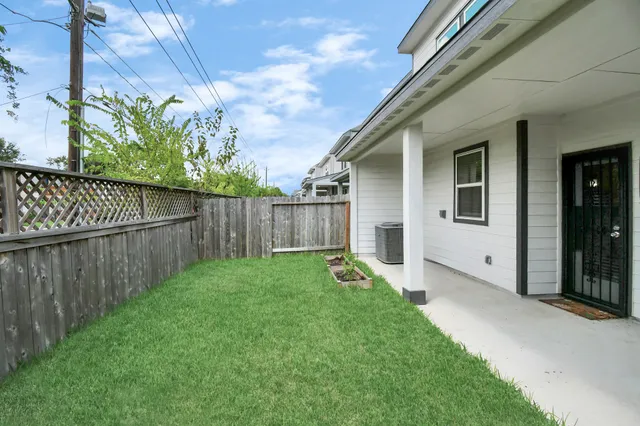 a view of a backyard with wooden fence