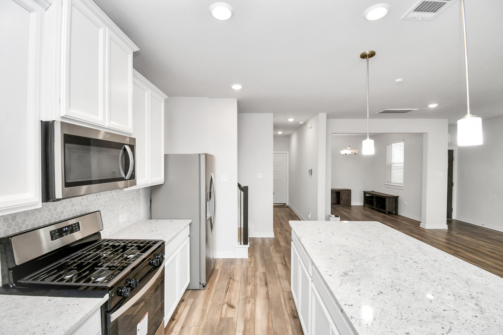 8213 Rising Stream Drive Houston, TX 77063 - Photo 5 of 21 a kitchen with a stove a sink and a refrigerator