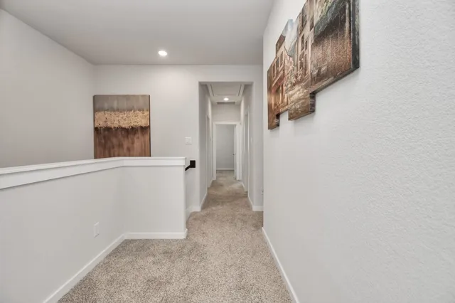 a view of a hallway with wooden floor and entryway