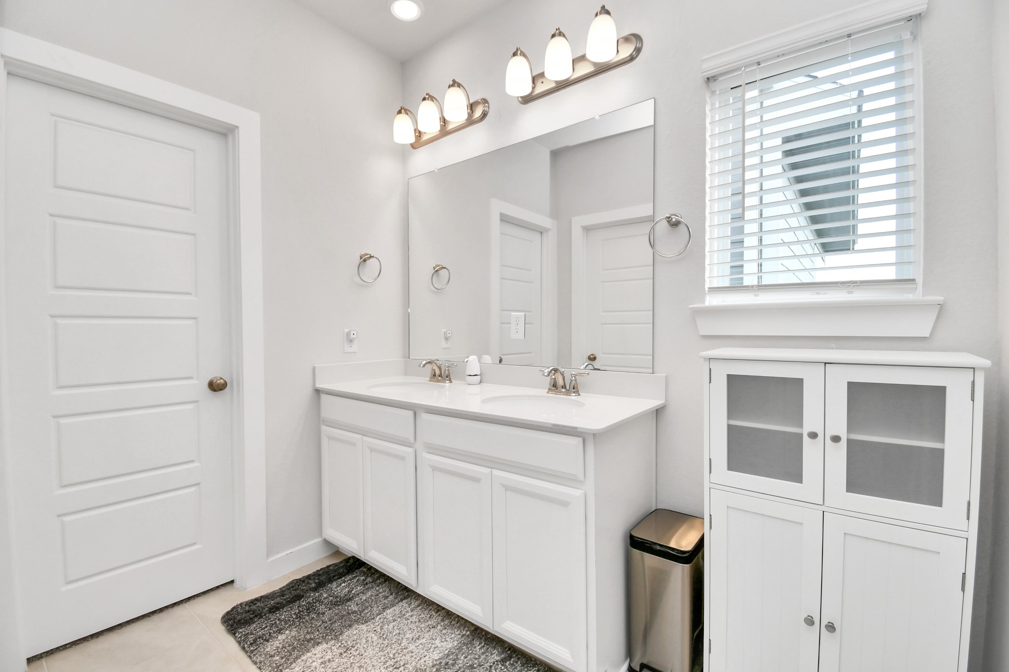 8213 Rising Stream Drive Houston, TX 77063 - Photo 10 of 21 a bathroom with a sink a vanity and a mirror