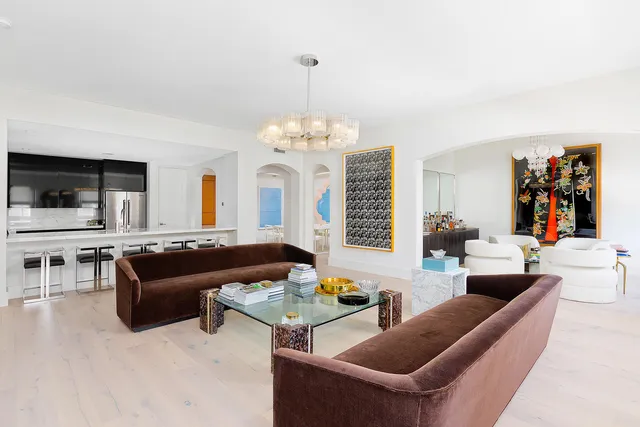 a living room with furniture and a chandelier