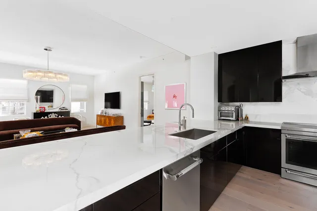 a kitchen with stainless steel appliances a sink and a microwave