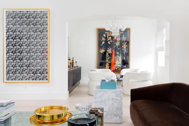 a living room with a couch and a chandelier