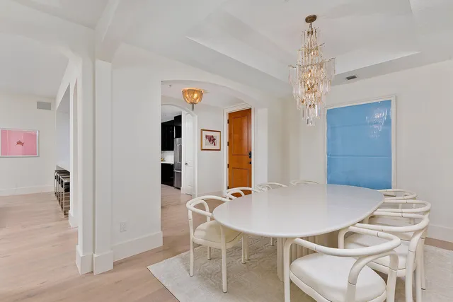a view of a dining room with furniture and chandelier