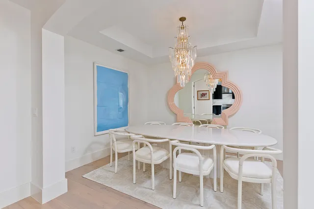 a view of a dining room with furniture and chandelier