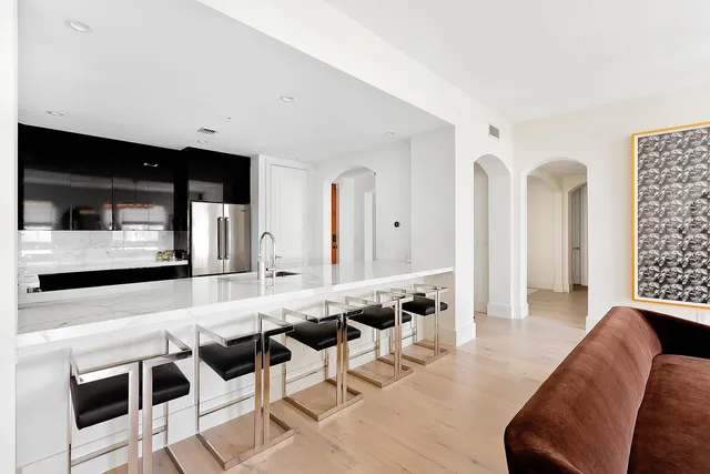 a living room with furniture a flat screen tv and white walls