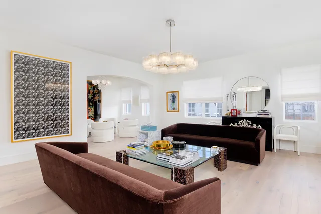 a living room with furniture and a chandelier