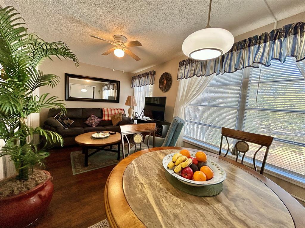 2260 Costa Rican Drive, Unit 50 Clearwater, FL 33763 - Photo 13 of 48 a living room with furniture a chandelier and a fireplace