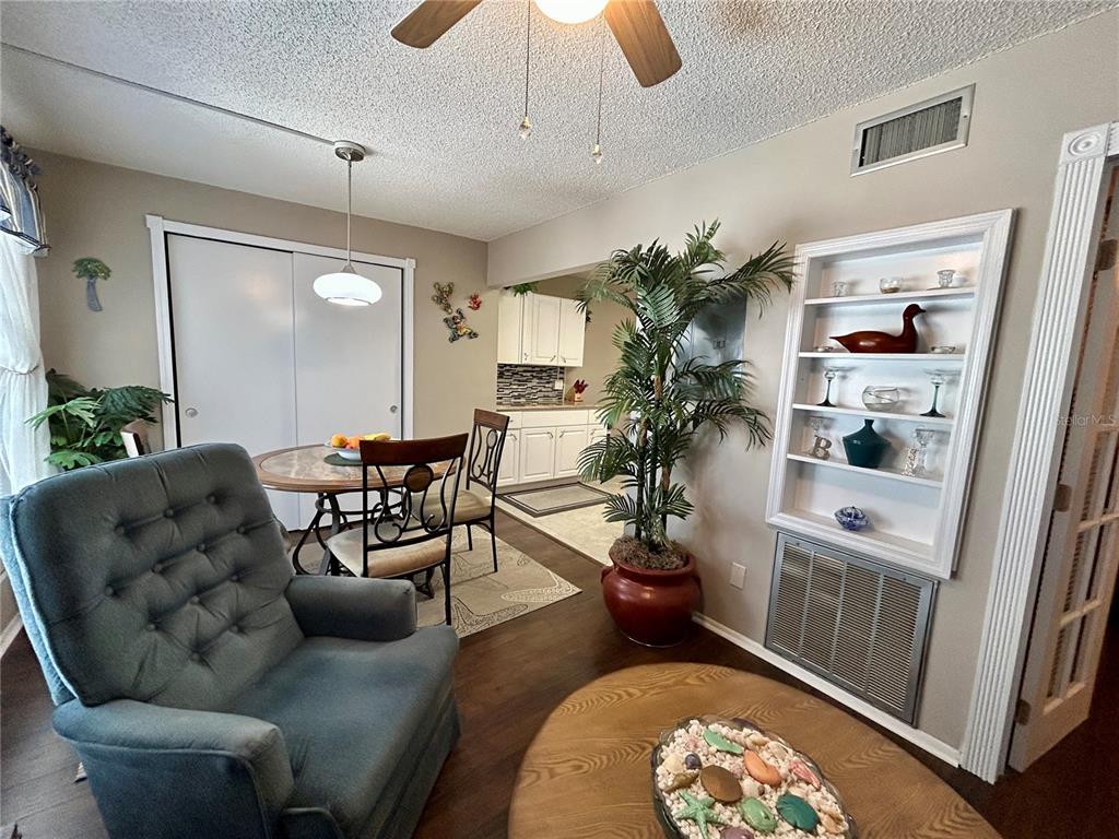 2260 Costa Rican Drive, Unit 50 Clearwater, FL 33763 - Photo 16 of 48 a living room with furniture a chandelier and a rug