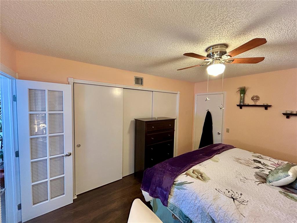 2260 Costa Rican Drive, Unit 50 Clearwater, FL 33763 - Photo 18 of 48 a bedroom with a bed and a chandelier