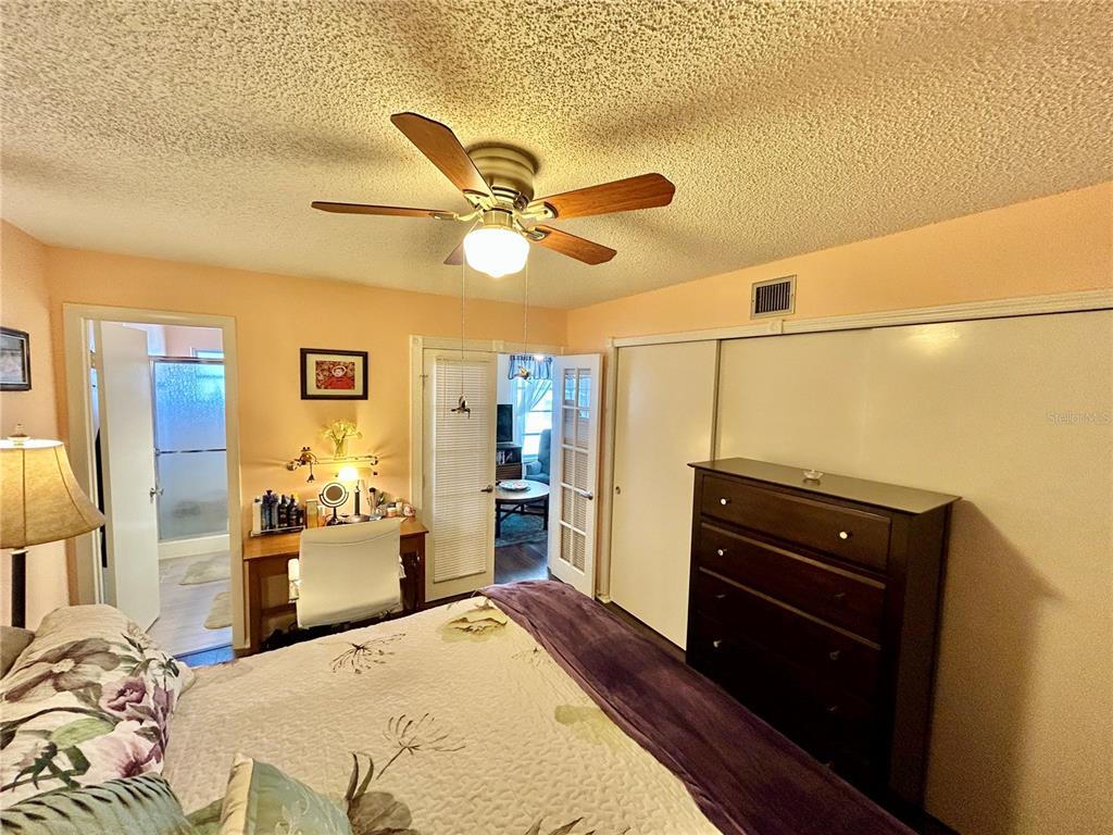 2260 Costa Rican Drive, Unit 50 Clearwater, FL 33763 - Photo 19 of 48 a bedroom with a bed and wooden floor