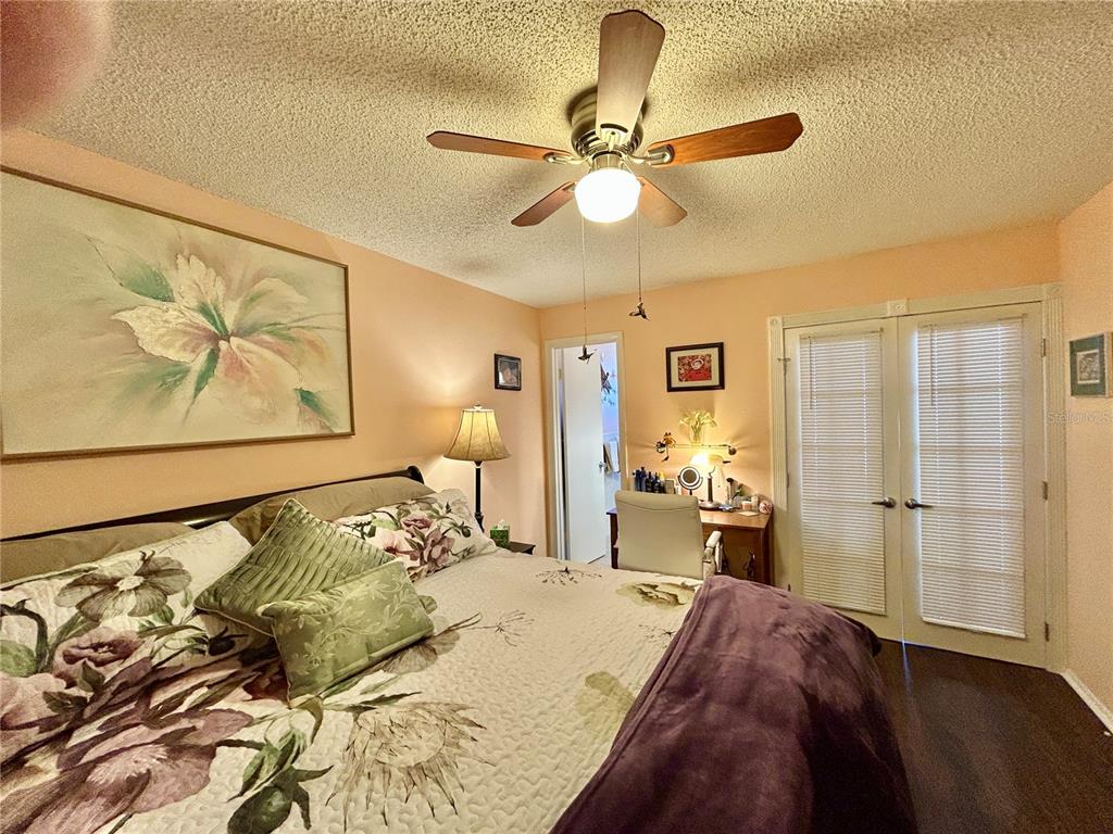 2260 Costa Rican Drive, Unit 50 Clearwater, FL 33763 - Photo 20 of 48 a bedroom with a bed and wooden floor