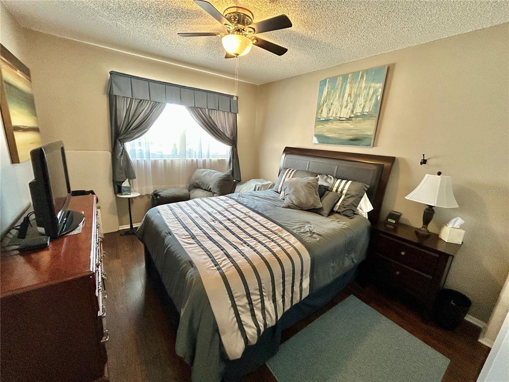 2260 Costa Rican Drive, Unit 50 Clearwater, FL 33763 - Photo 23 of 48 a bedroom with bed and wooden floor