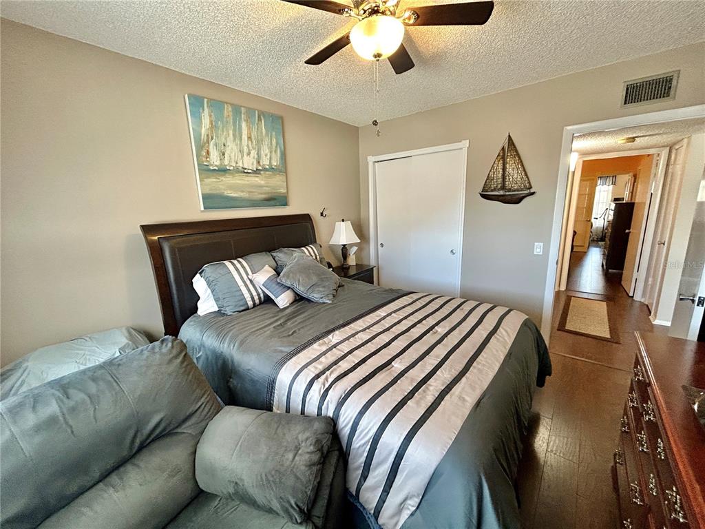 2260 Costa Rican Drive, Unit 50 Clearwater, FL 33763 - Photo 25 of 48 a bedroom with a large bed and a chandelier