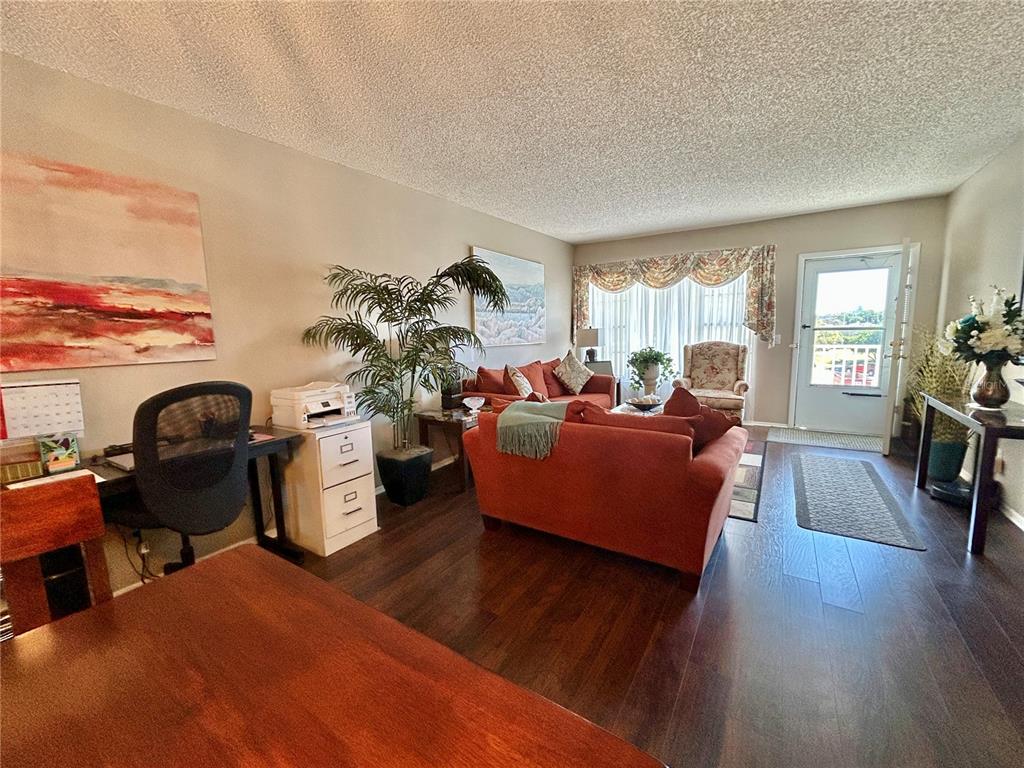 2260 Costa Rican Drive, Unit 50 Clearwater, FL 33763 - Photo 5 of 48 a living room with furniture window and wooden floor