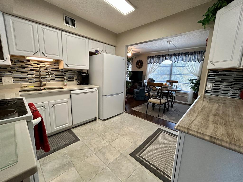 2260 Costa Rican Drive, Unit 50 Clearwater, FL 33763 - Photo 7 of 48 a kitchen with sink cabinets and window