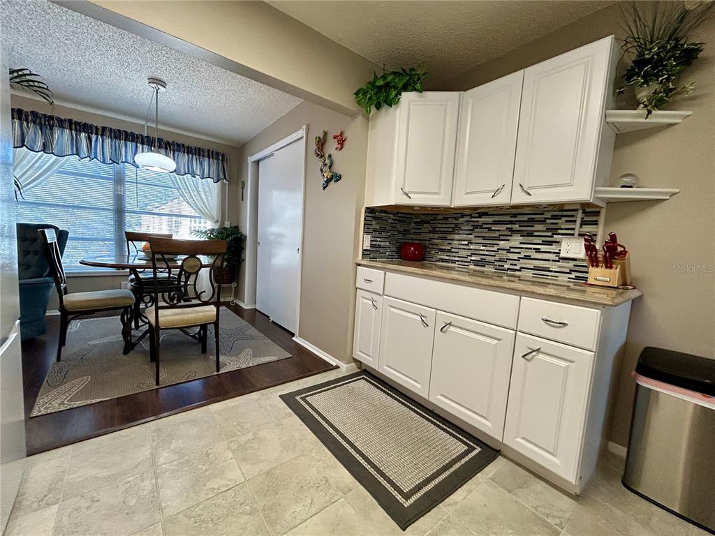 2260 Costa Rican Drive, Unit 50 Clearwater, FL 33763 - Photo 10 of 48 a kitchen with white cabinets and window