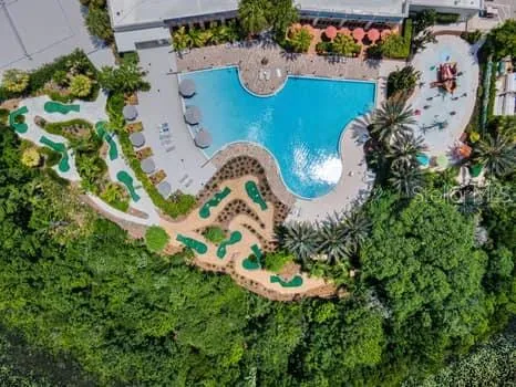 an aerial view of a house with a yard and swimming pool