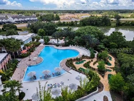 an aerial view of residential house with outdoor space and lake view