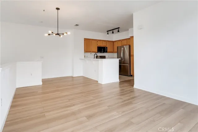 a view of a room with a flat screen tv and wooden floor