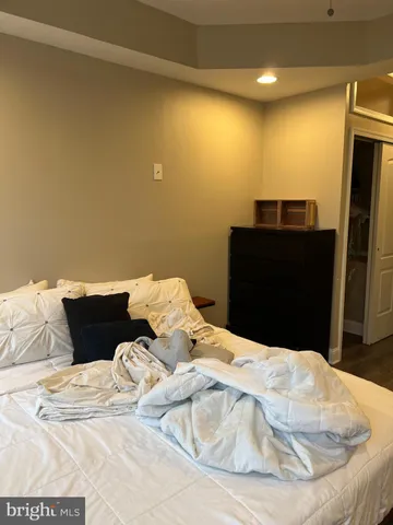 a bedroom with a bed and a black countertop