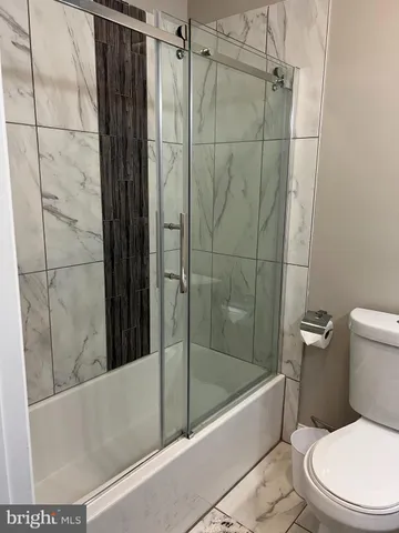 a bathroom with a toilet and shower