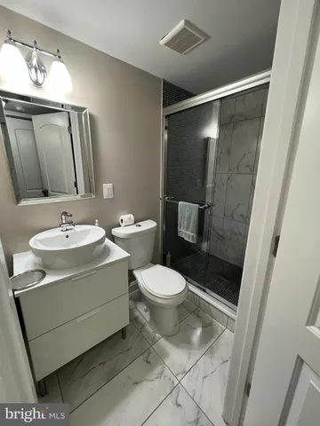 a utility room with dryer washer and a view of living