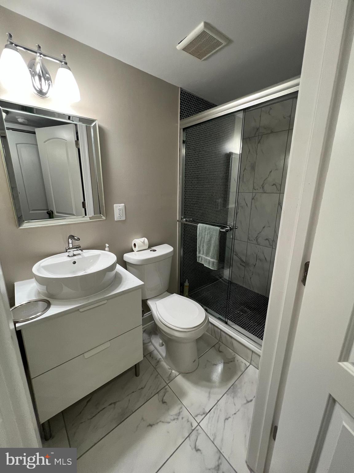 3319 Noble Street Baltimore, MD 21224 - Photo 29 of 31 a white toilet sitting next to a bathroom sink