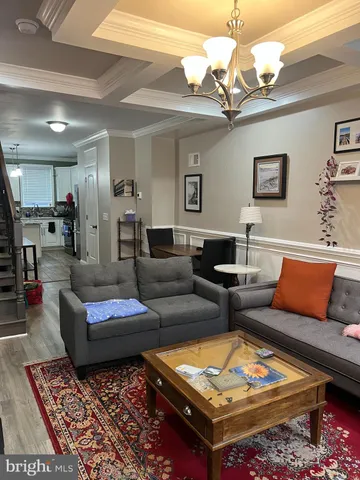 a living room with furniture a rug and a chandelier