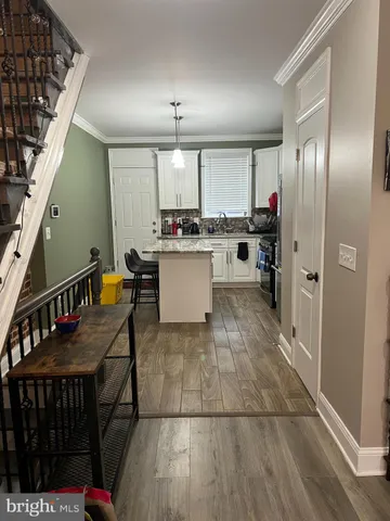a kitchen with refrigerator and cabinets