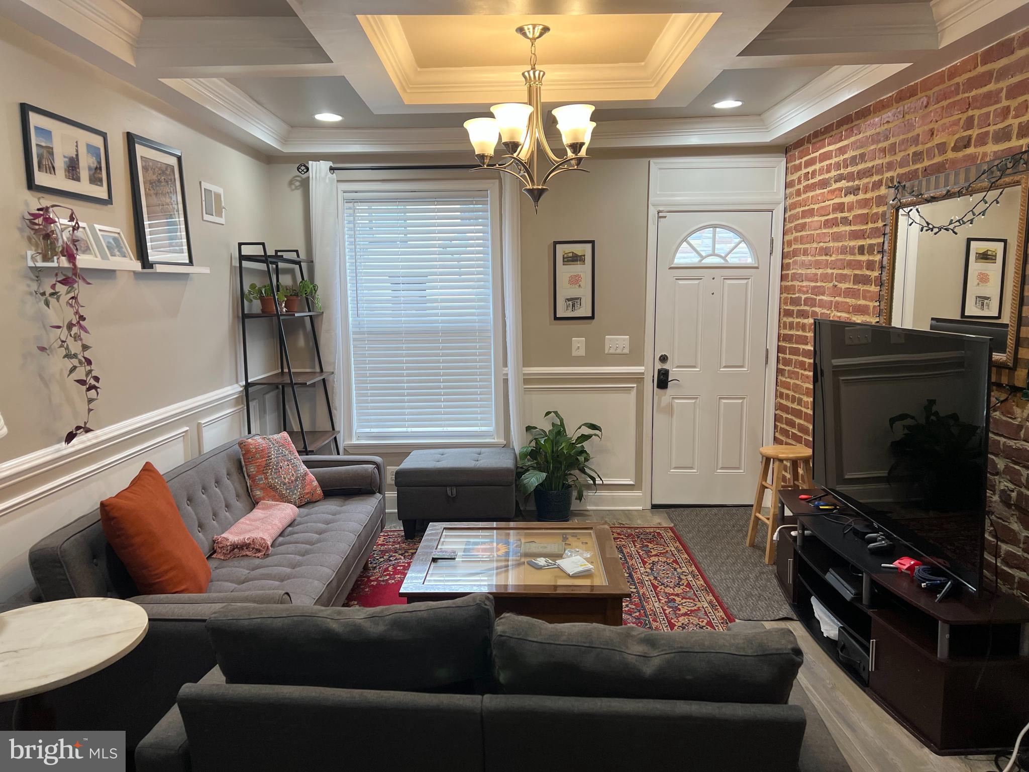 3319 Noble Street Baltimore, MD 21224 - Photo 6 of 31 a living room with furniture and a flat screen tv