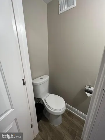 a white toilet sitting next to a sink