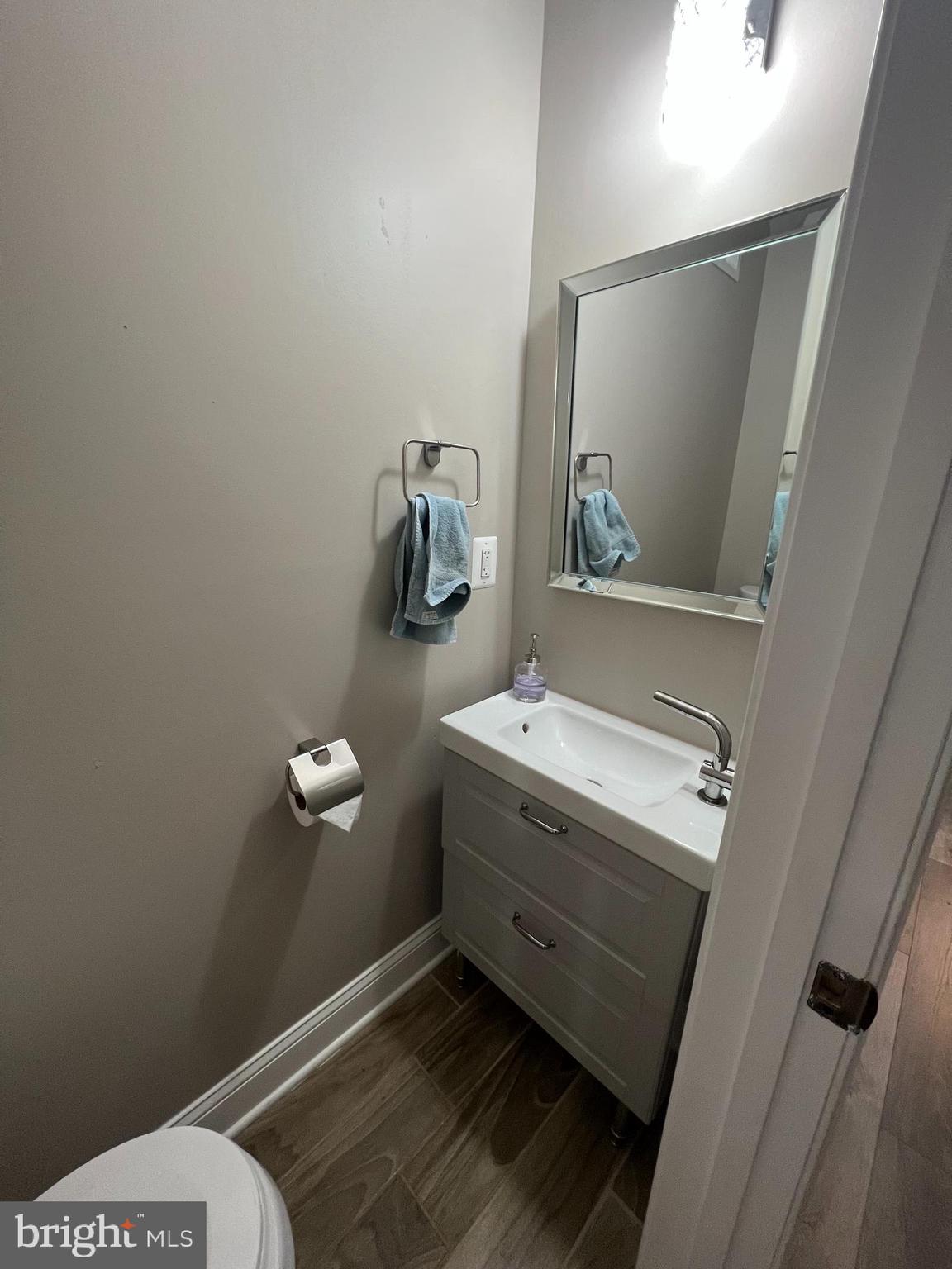 3319 Noble Street Baltimore, MD 21224 - Photo 8 of 31 a room with a wooden floor and mirror