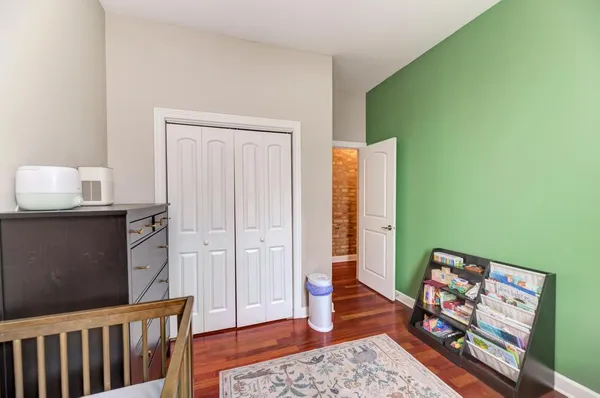 a bedroom with furniture and wooden floor