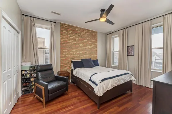 a bedroom with a bed couch and window