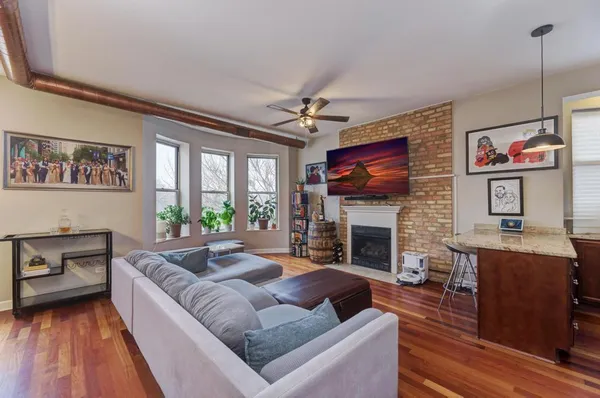 a living room with furniture and a fireplace