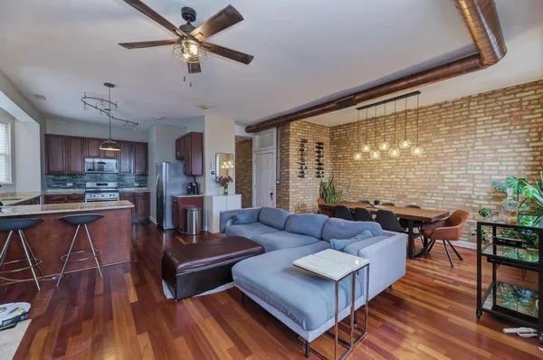 a living room with fireplace furniture and a wooden floor