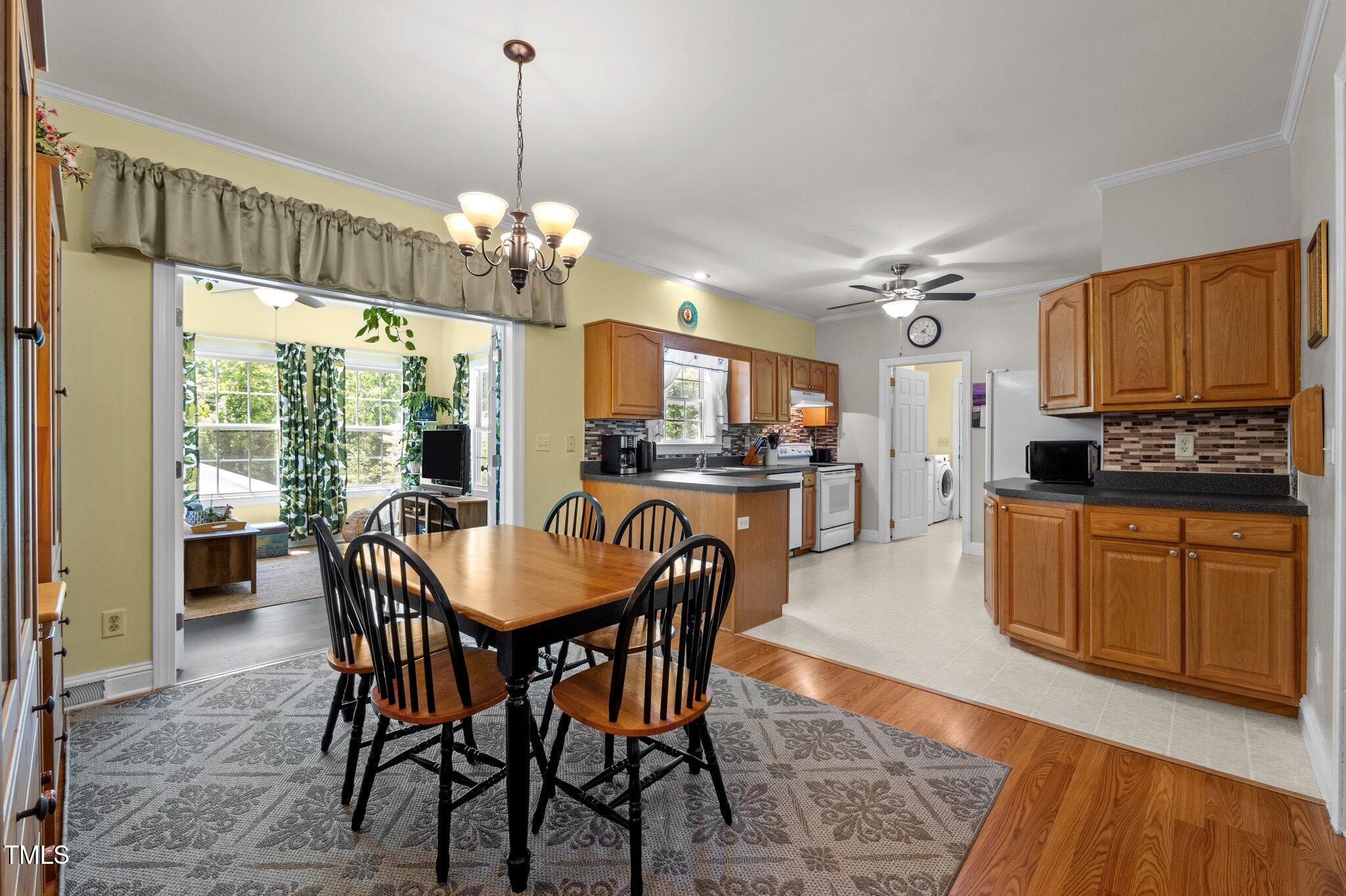 5013 West Pool Road Rougemont, NC 27572 - Photo 8 of 34 a kitchen with granite countertop a table chairs stove and refrigerator