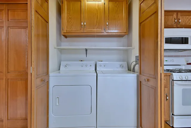 a bathroom with a granite countertop toilet a sink and a mirror