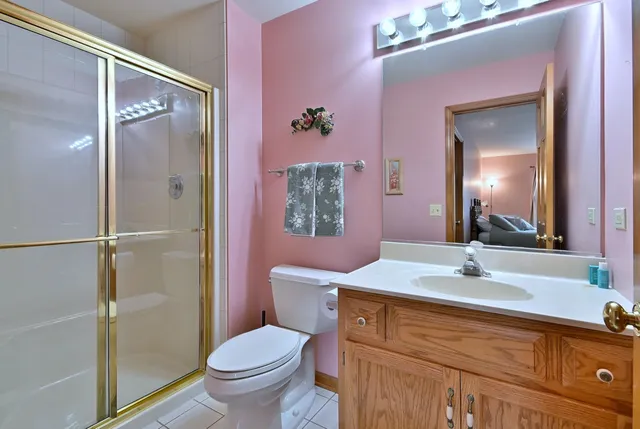 a spacious bedroom with a bed and a chandelier