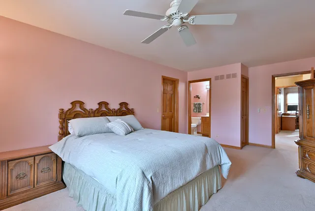 a bedroom with a bed and a desk