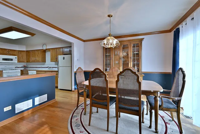 a view of a dining room with furniture and chandelier