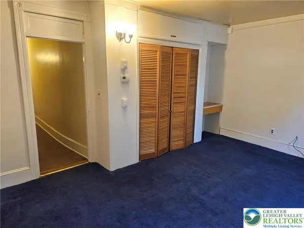 a view of empty room with closet